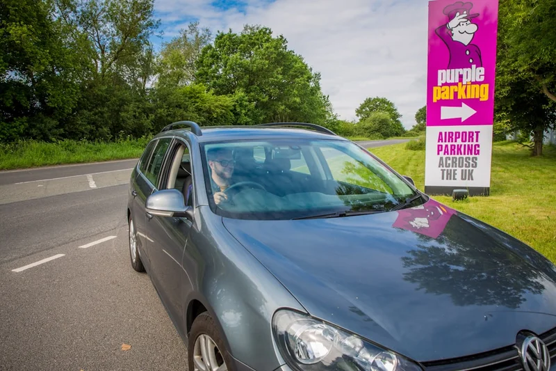 Car pulling into Purple Parking car park entrance - Holiday Extras